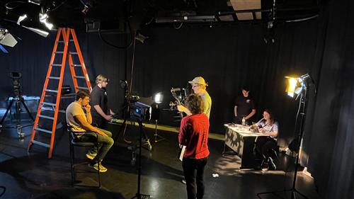 Studio production shot of crew blocking the scene
